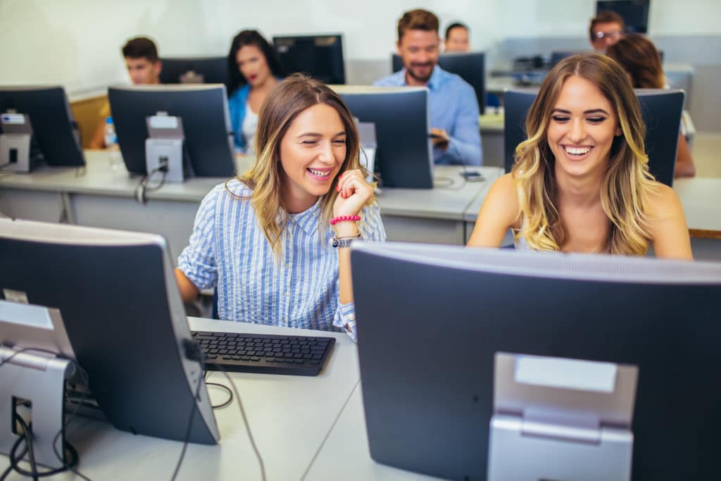 Adobe girls laughing in computer class scaled e
